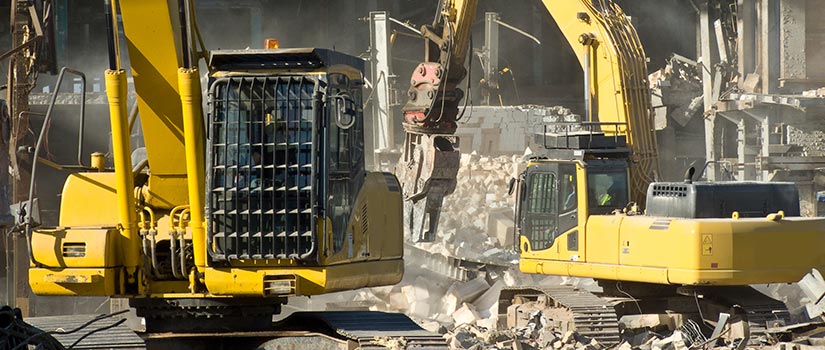 two diggers operating on a construction site and making noise